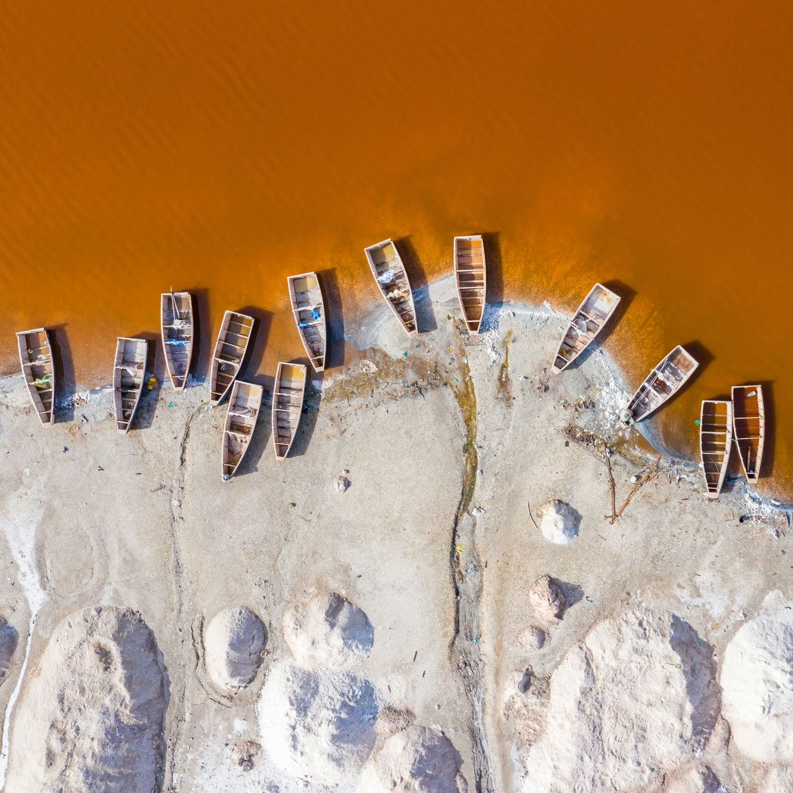 Salt collectors’ boats on the shore of Lac Rose